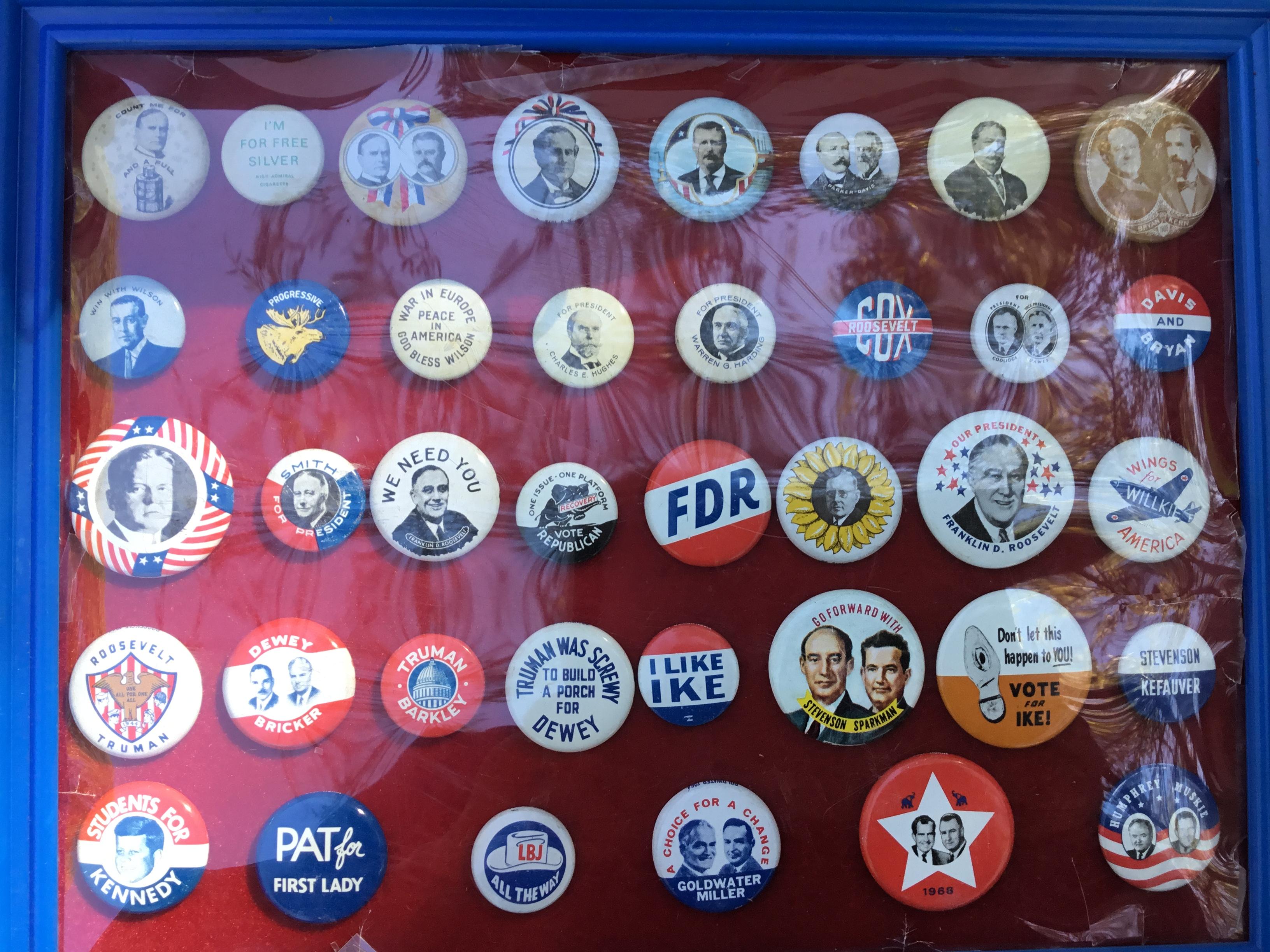 Group of Presidential buttons in a plastic frame; 38 total buttons