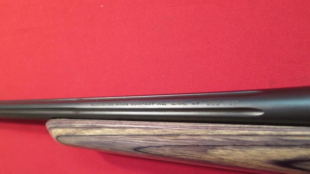 Remington 700 .300wsm bolt, camo, shot only about 10x, tag#1189