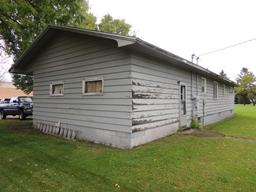 Lot 7: 405 5th St SE.  Rambler style home with wood siding, 26x48 home, 3 b