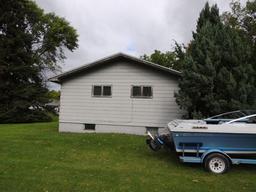 Lot 7: 405 5th St SE.  Rambler style home with wood siding, 26x48 home, 3 b