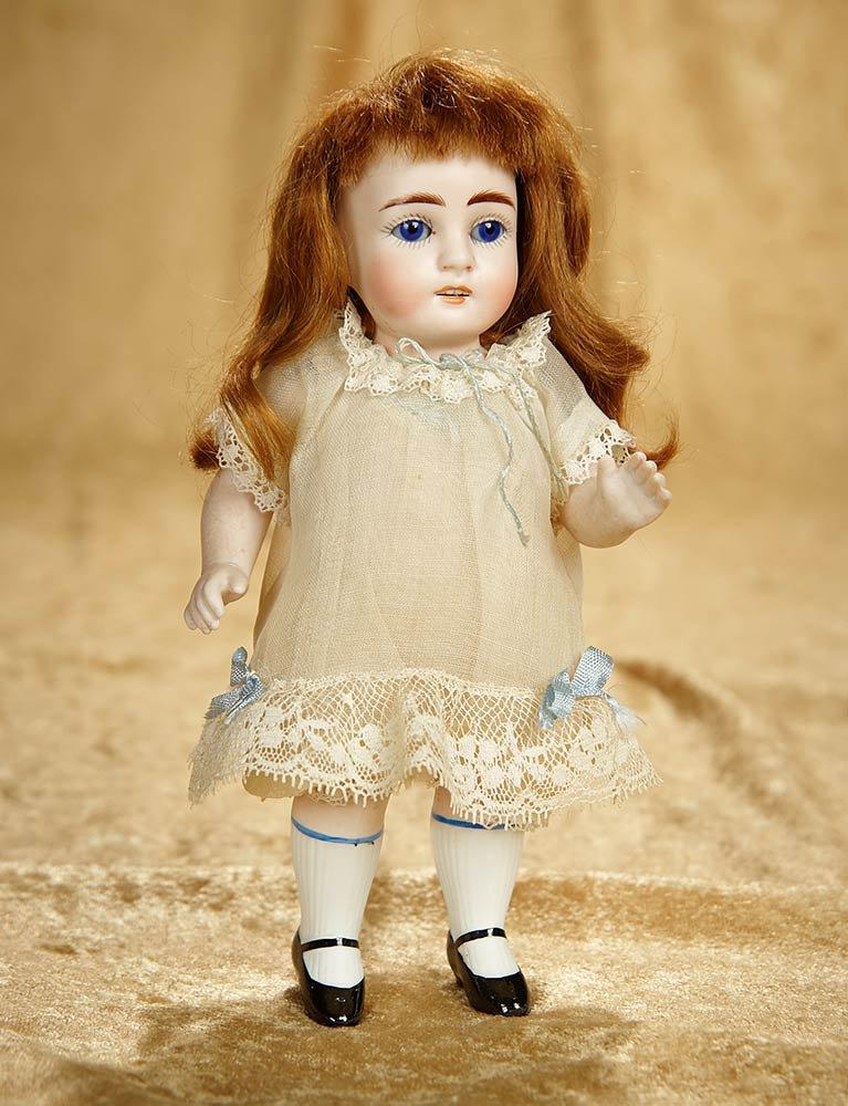 7" German all-bisque miniature doll with cobalt blue eyes. $300/400