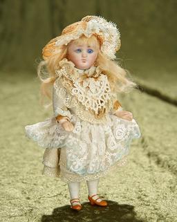 7" German bisque petite child with lovely antique costume. $200/300