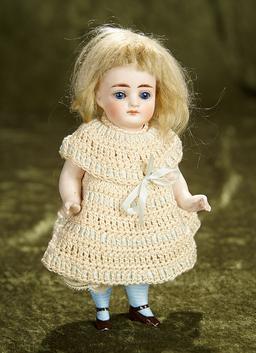 7" German all-bisque miniature doll with sleep eyes and closed mouth. $400/500