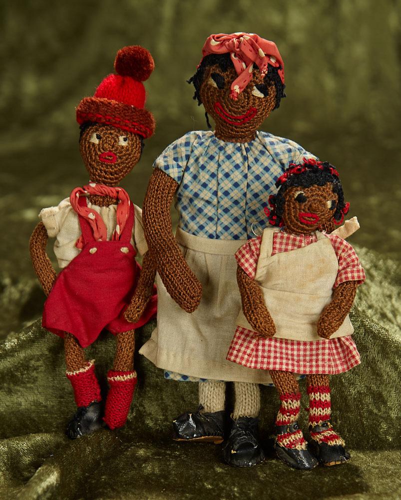 5 1/2" - 8" Trio of brown-complexioned knit folk dolls with embroidered features. $200/400