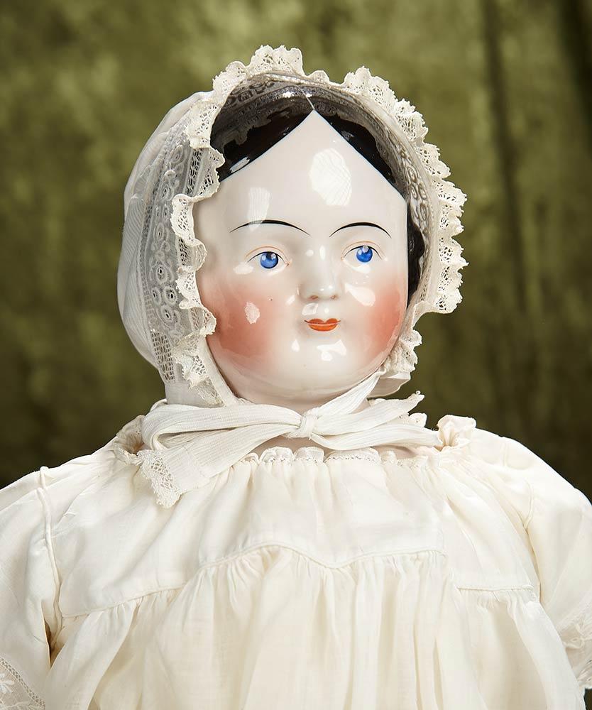 26" German porcelain doll with pink-tinted complexion and nice antique costume. $400/500