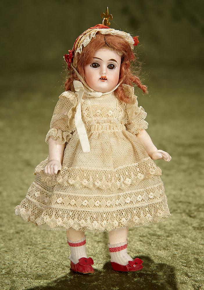 Petite 7" German bisque child, rare model 192, by Kammer and Reinhardt, lace costume. $400/500