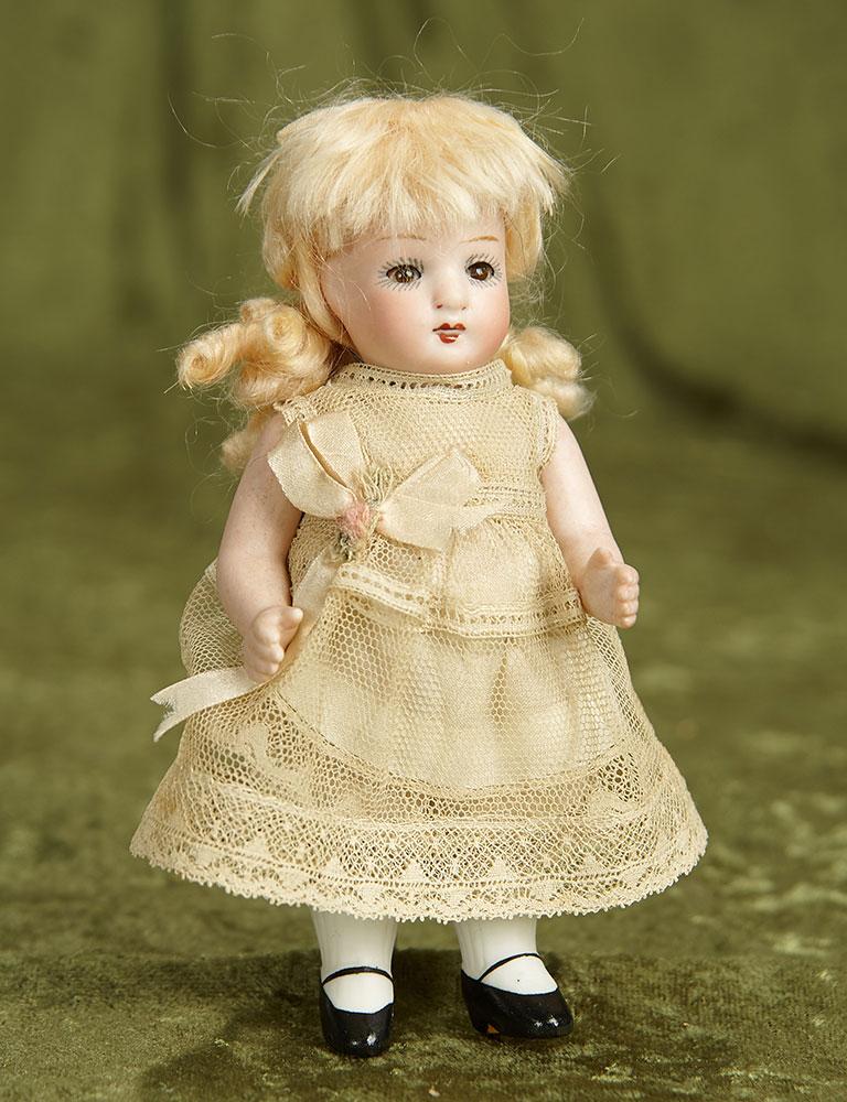 5 1/2" German all-bisque miniature doll with glass sleep eyes. $200/300