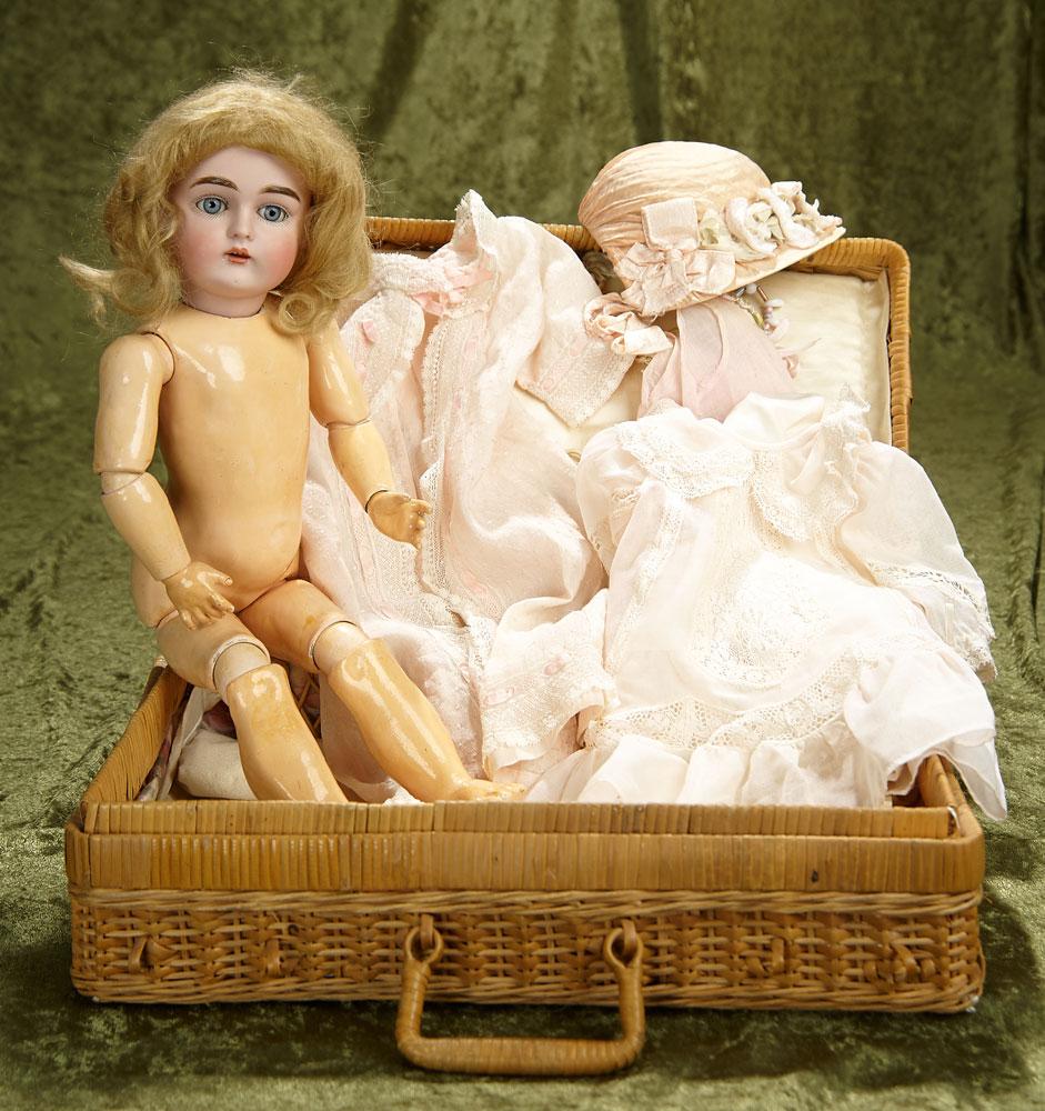 16" German bisque child, 167, by Kestner in wicker basket with costumes. $800/1000