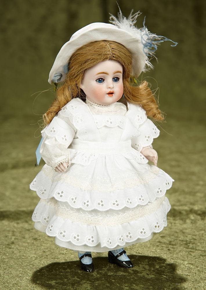 8" German all-bisque miniature doll by Kestner with painted blue stockings. $400/500