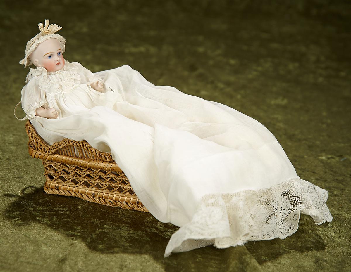 5" German all-bisque character baby, antique gown, in woven bassinette. $400/500