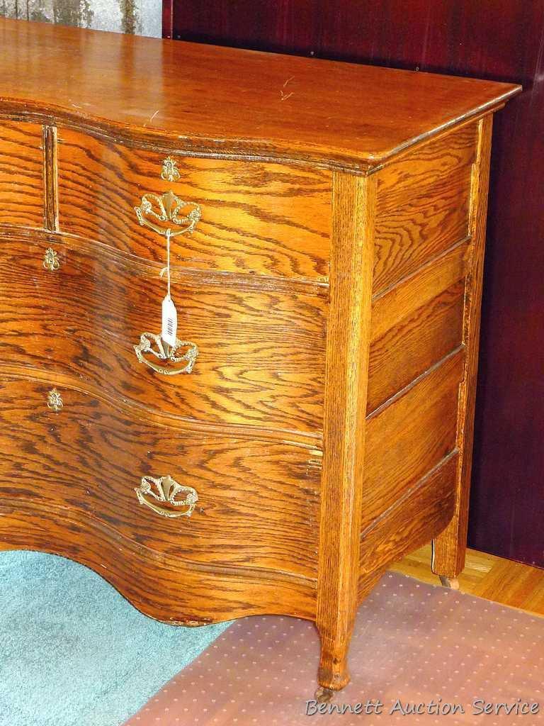 Antique serpentine four drawer dresser and wall mirror. Dresser is approx. 42-1/2" w x 19"d x 34" h.