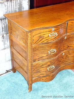 Antique serpentine four drawer dresser and wall mirror. Dresser is approx. 42-1/2" w x 19"d x 34" h.