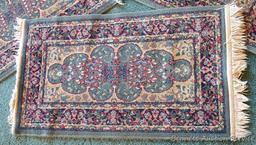 Three smaller rugs, plus one runner. Three rugs measure 2'x4', no stains noted. One runner measures