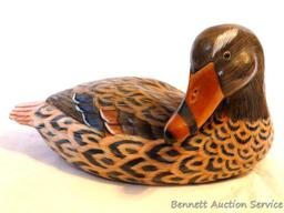 Carved wooden duck is approx. 12" long and in good condition with a couple of small chips.