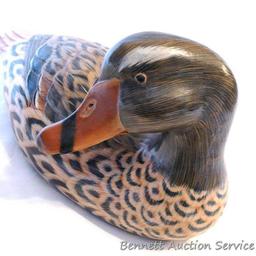 Carved wooden duck is approx. 12" long and in good condition with a couple of small chips.