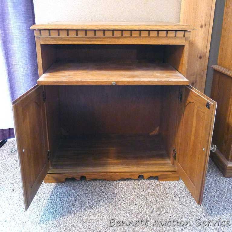 Swiveling TV stand is approx. 28" wide x 17" deep x 31" tall. Has a slide out shelf and storage