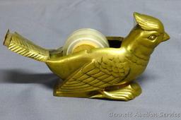 Lovely brass cardinal tape dispenser is unique and in good shape. Measures 6" long overall.