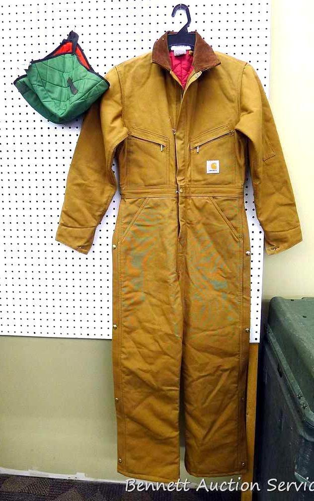 Carhartt insulated coveralls, 34 regular, appears new; two insulated hard hat liners.