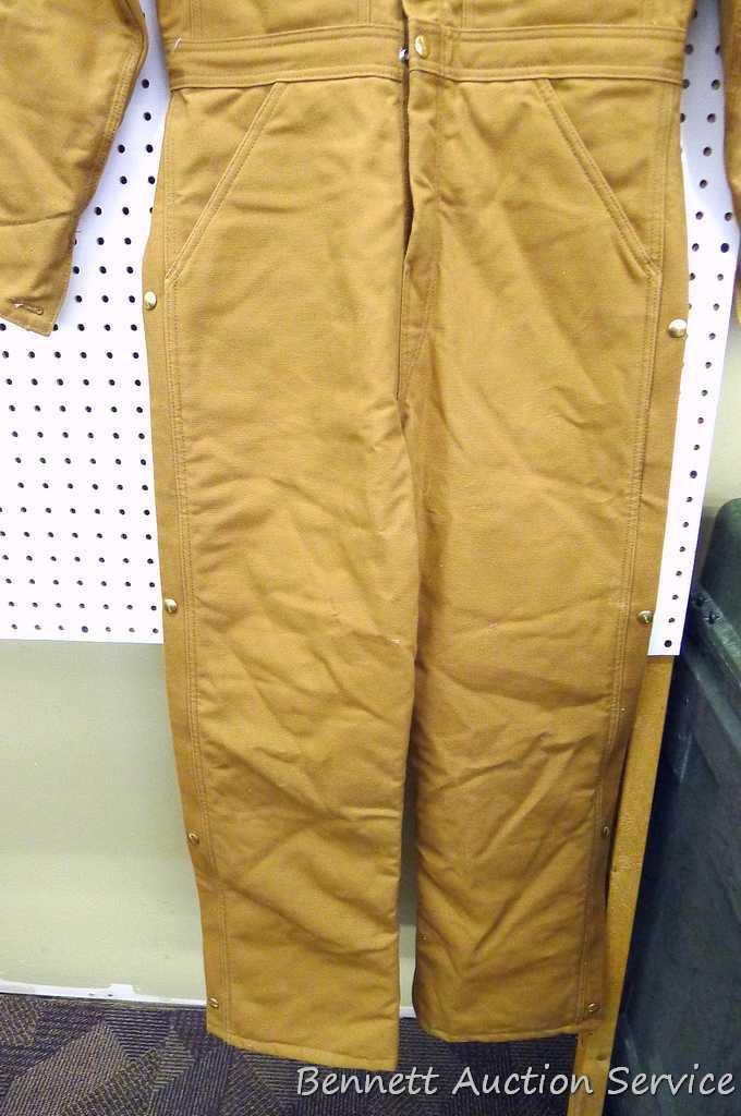 Carhartt insulated coveralls, 34 regular, appears new; two insulated hard hat liners.
