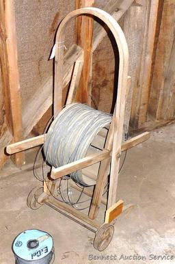 Cute little electric wire cart with partial spool of electric wire. Cart is 13" x 39" tall.
