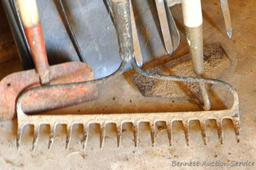 Assortment of hand tools including hoe, rake, scraper, hay fork, flat bottom shovel, and pitch fork.