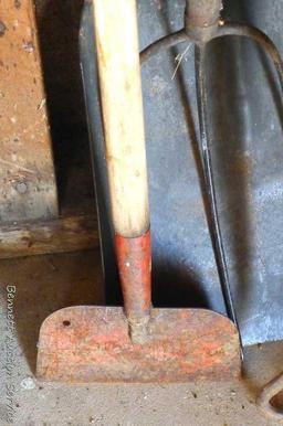 Assortment of hand tools including hoe, rake, scraper, hay fork, flat bottom shovel, and pitch fork.