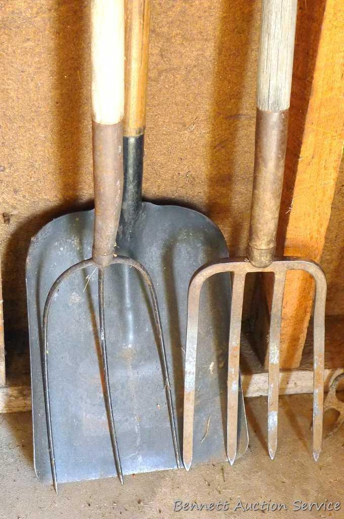 Assortment of hand tools including hoe, rake, scraper, hay fork, flat bottom shovel, and pitch fork.