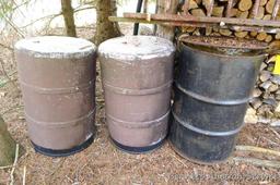 One metal and two plastic 55 gallon barrels. Metal barrel has a removable lid and looks to be filled