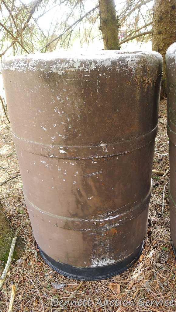 One metal and two plastic 55 gallon barrels. Metal barrel has a removable lid and looks to be filled