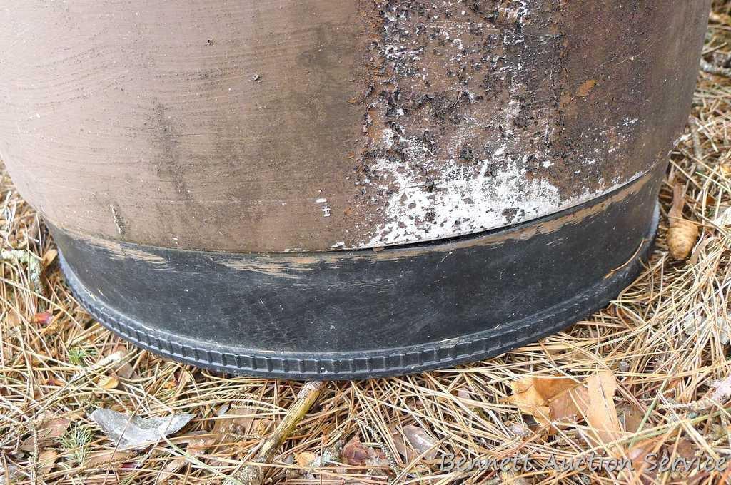 One metal and two plastic 55 gallon barrels. Metal barrel has a removable lid and looks to be filled