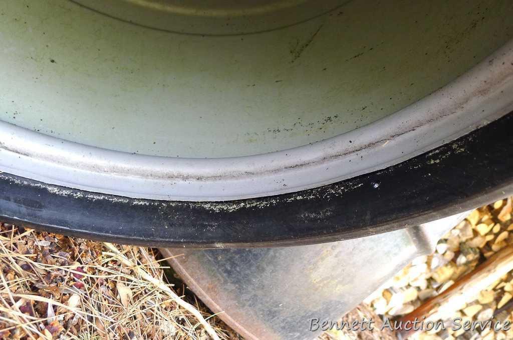 One metal and two plastic 55 gallon barrels. Metal barrel has a removable lid and looks to be filled