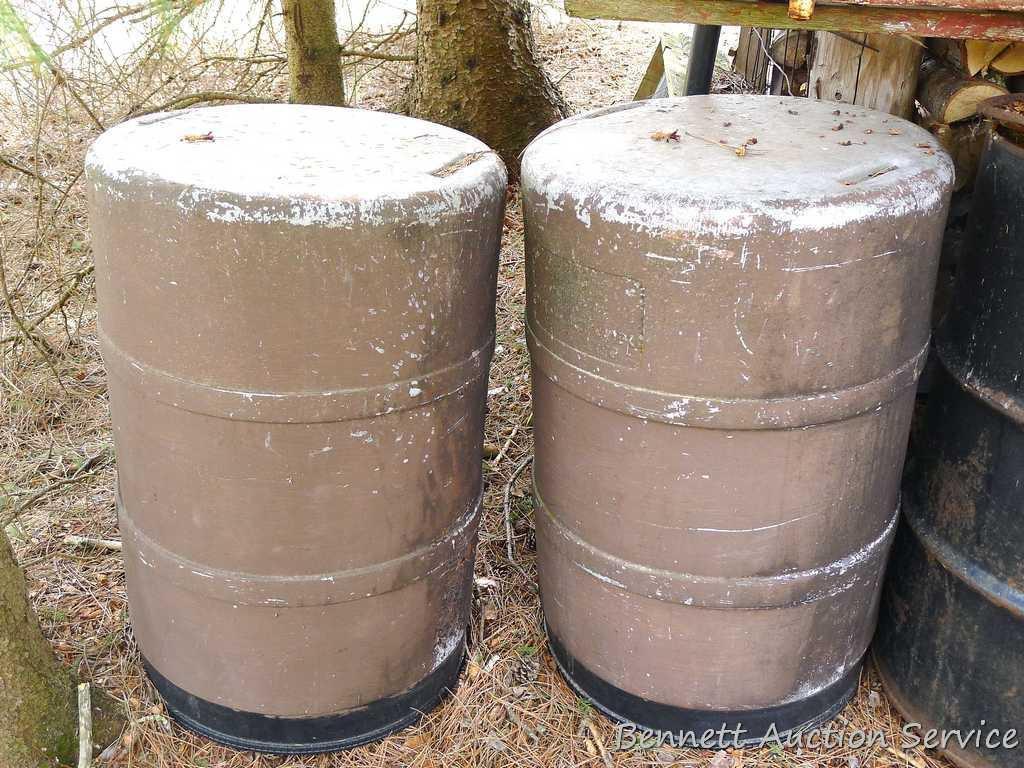 One metal and two plastic 55 gallon barrels. Metal barrel has a removable lid and looks to be filled