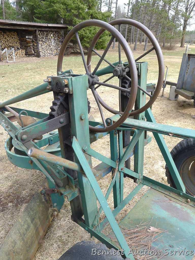 Pull behind road grader with 9' blade that swivels and tilts. Height and bevel adjustment works.