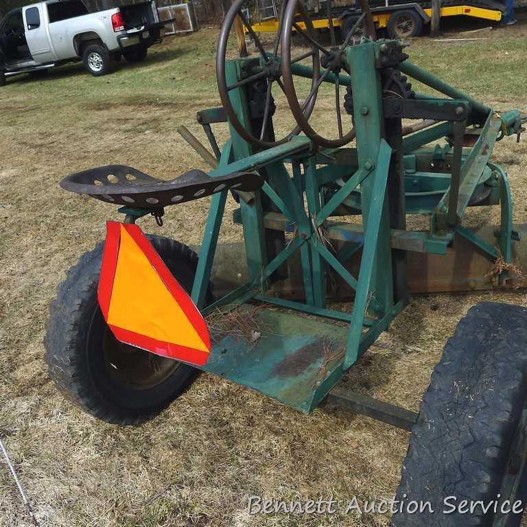 Pull behind road grader with 9' blade that swivels and tilts. Height and bevel adjustment works.