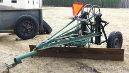 Pull behind road grader with 9' blade that swivels and tilts. Height and bevel adjustment works.