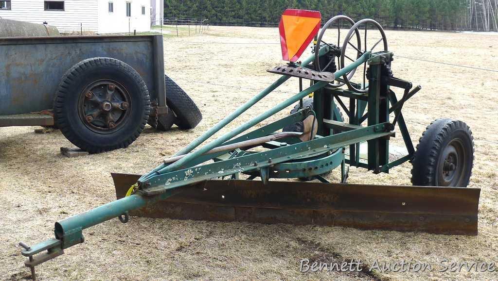 Pull behind road grader with 9' blade that swivels and tilts. Height and bevel adjustment works.