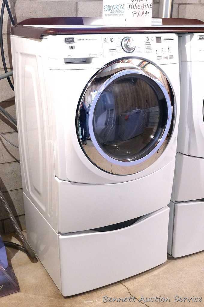 Maytag 5000 Series washer and dryer with storage bases and work top. Washer Model MHWE550WW01, dryer