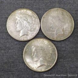 Three silver Peace dollars including 1922, 1922-S, 1922-D.