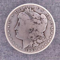 1903-S Morgan silver dollar. Pleasant coin with uniform wear and two old worn dings in the rim above