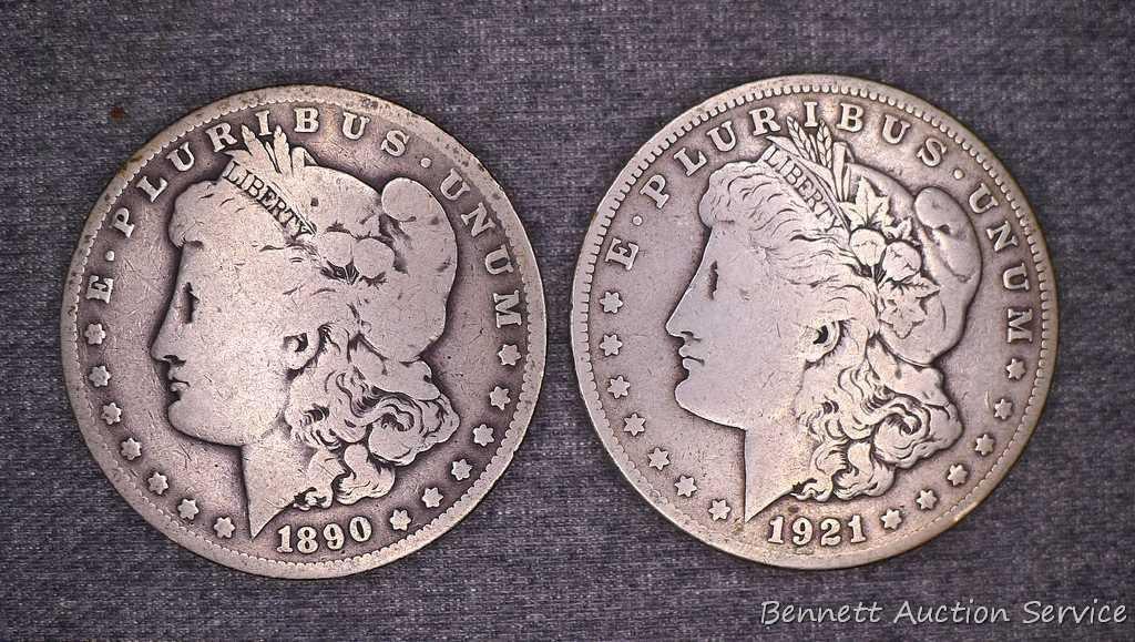 Two Morgan silver dollars including 1890-O and 1921-S.