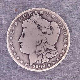 Two Morgan silver dollars including 1890-O and 1921-S.