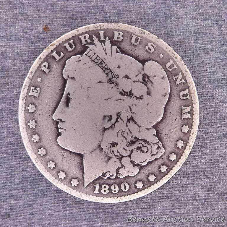 Two Morgan silver dollars including 1890-O and 1921-S.