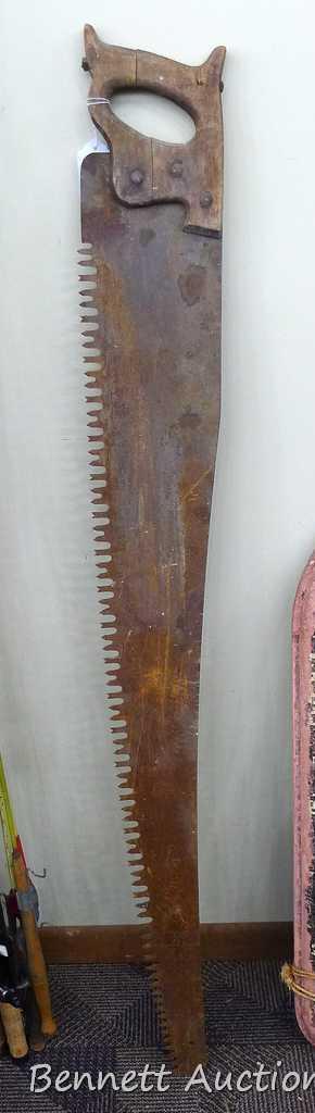 Vintage hand saw is 53" long x 7".