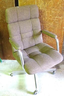 Brown padded swivel office chair. Rolls easily and is very comfortable.