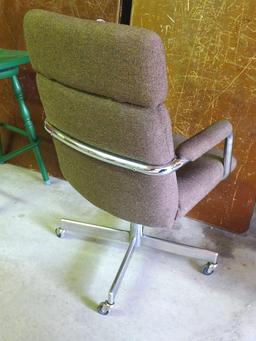 Brown padded swivel office chair. Rolls easily and is very comfortable.