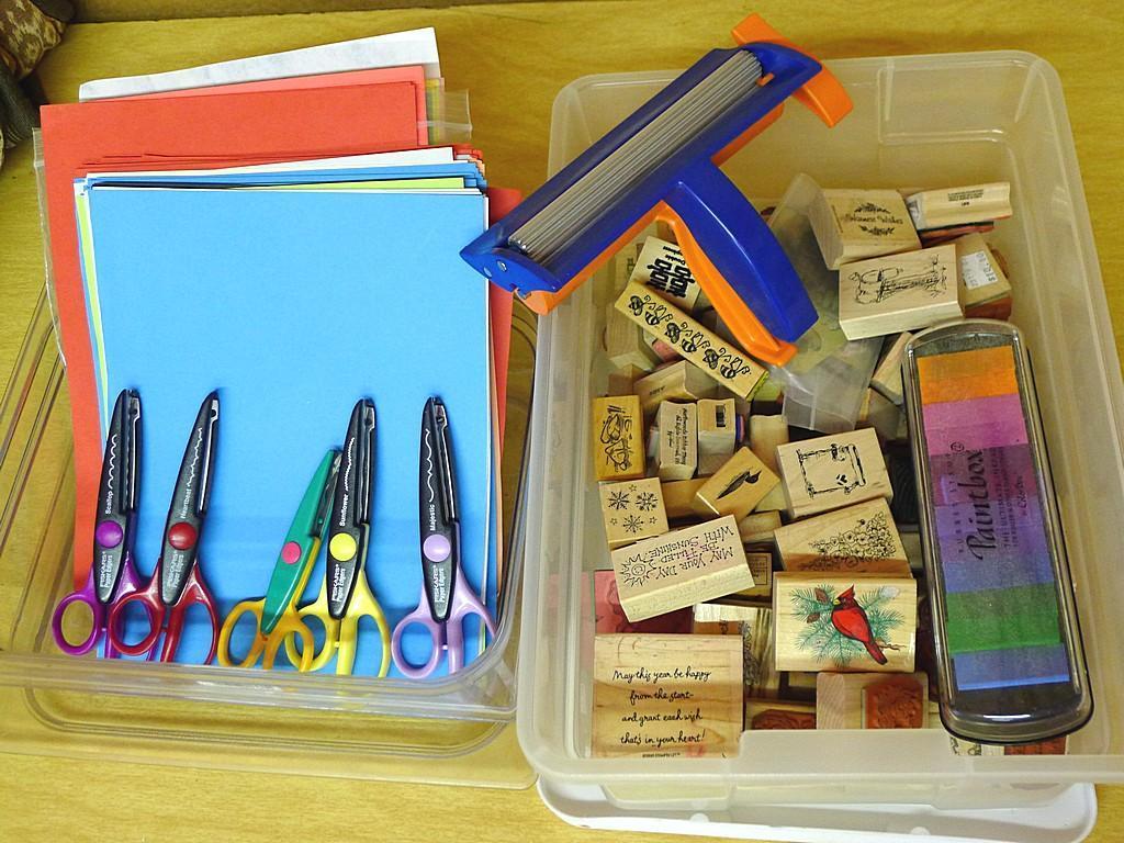 Rubber stamps, inkpad, decorative scissors, crimper and paper.