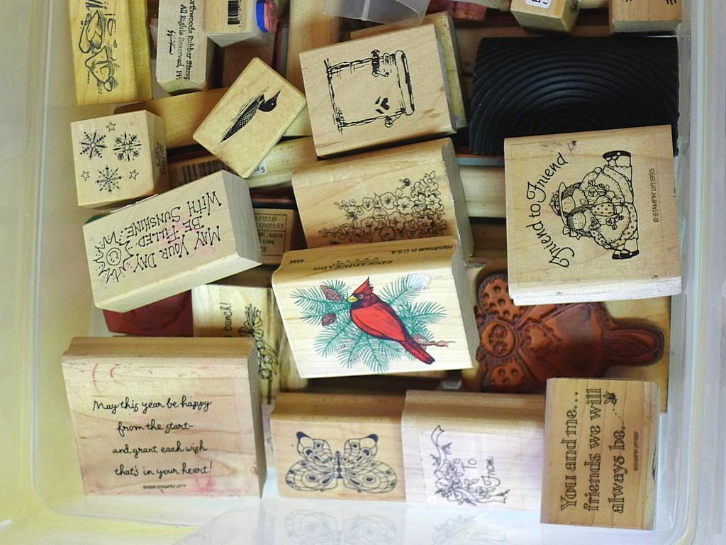 Rubber stamps, inkpad, decorative scissors, crimper and paper.