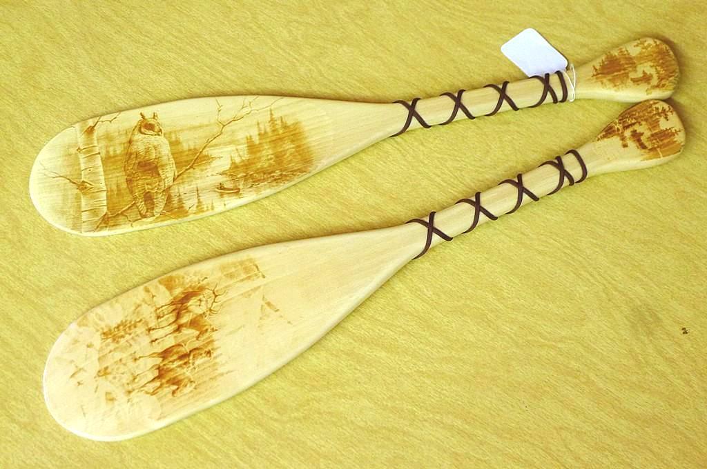 Two decorative paddles made in Wisconsin. Each paddle is 24" long.