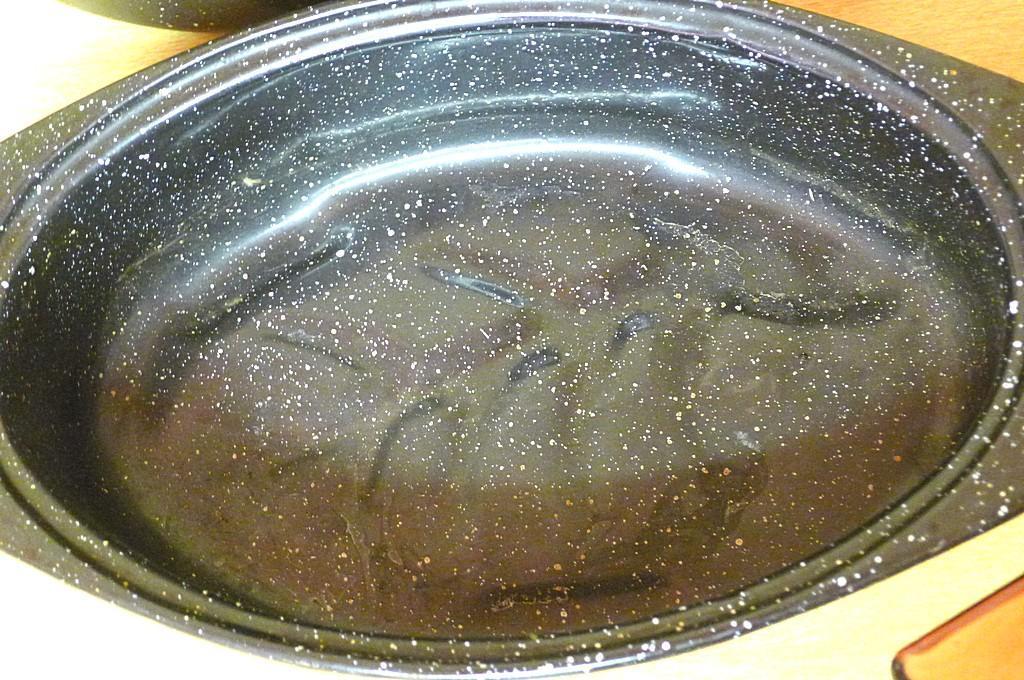 18" wide enameled roaster, smaller roaster, two glass Vision by Corning glass saucepans with lids.