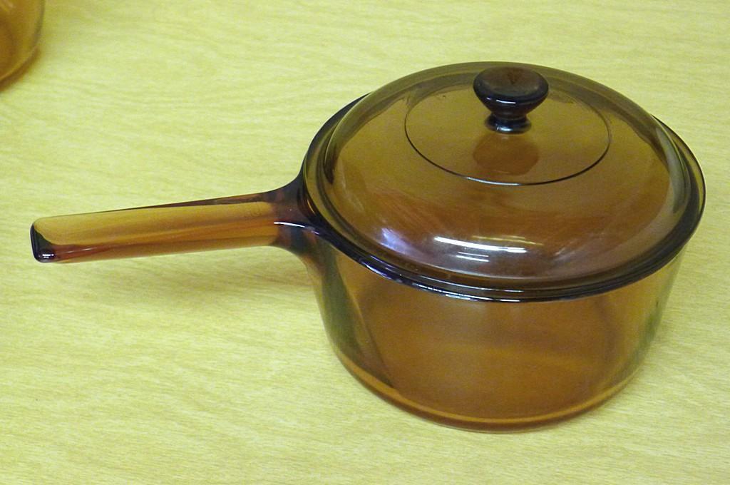 18" wide enameled roaster, smaller roaster, two glass Vision by Corning glass saucepans with lids.